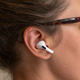 A profile photo of a woman wearing the new Apple AirPods Pro 2nd Generation earbuds.